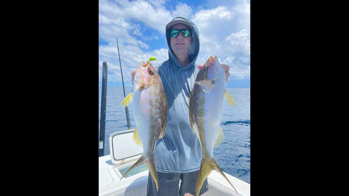 Geoff Szymanski poses with a pair of yellowtail snapper caught fishing in 100 feet of water in the Gulf of Mexico.