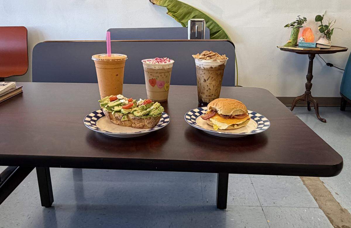 Some popular menu items at the Smiley Face Cafe, 923 10th St. E., Palmetto, include the Sunny Days smoothie (back left), Cupid Cookie Latte (back center) for Valentine’s Day, Cereal Killer Cold Brew (back right), avocado toast (front left) and the Smiley Face Sando (front right), which is bacon, egg and cheese on a Martin’s roll.