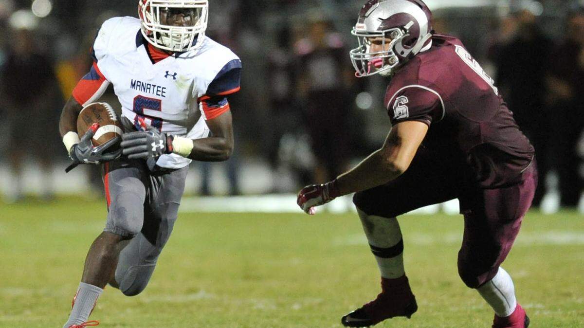 Manatee hurricane Lorenz Allen breaks a takle for a touchdown run
