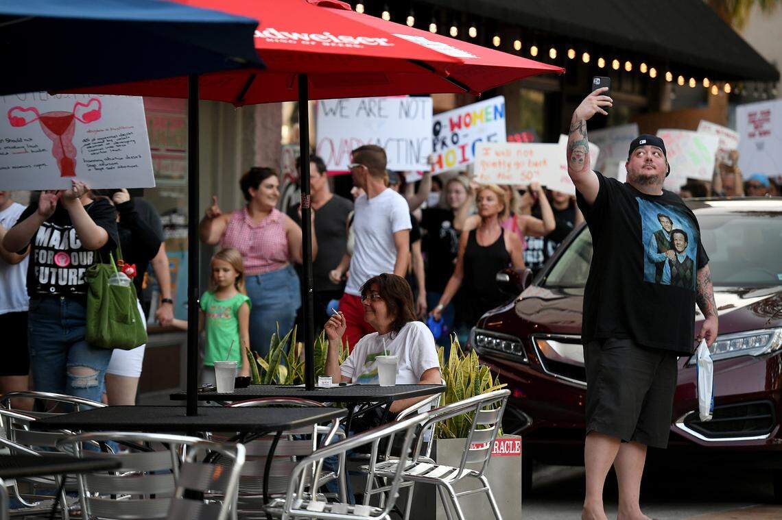 A man takes a selfie as over a hundred people joined a march and rally organized by Women’s Voices of SW Florida to support women’s rights to choose abortion on May 4, 2022. The group met at the Central Library and marched to the Historic Courthouse.