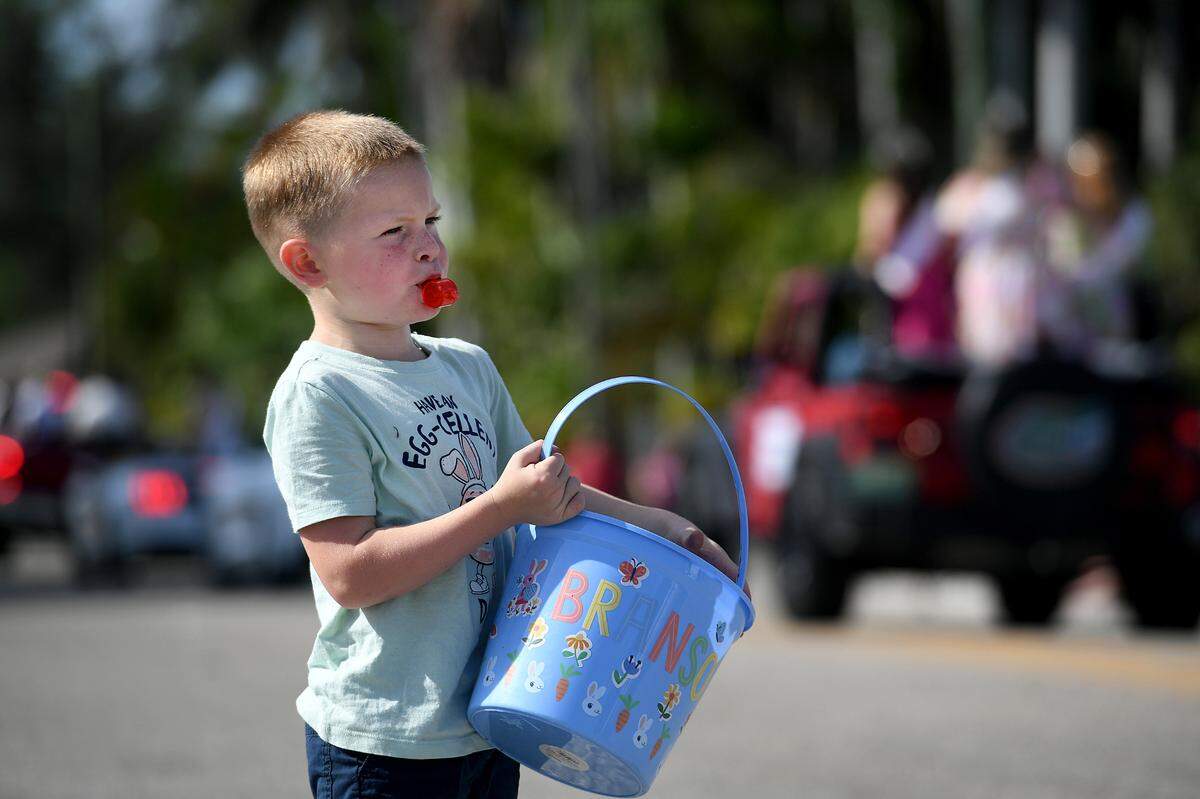 A young whistle-blower seeks beads during the Hernando DeSoto Historical Society’s Children’s Parade on Friday, April 7, 2023 in Palmetto.