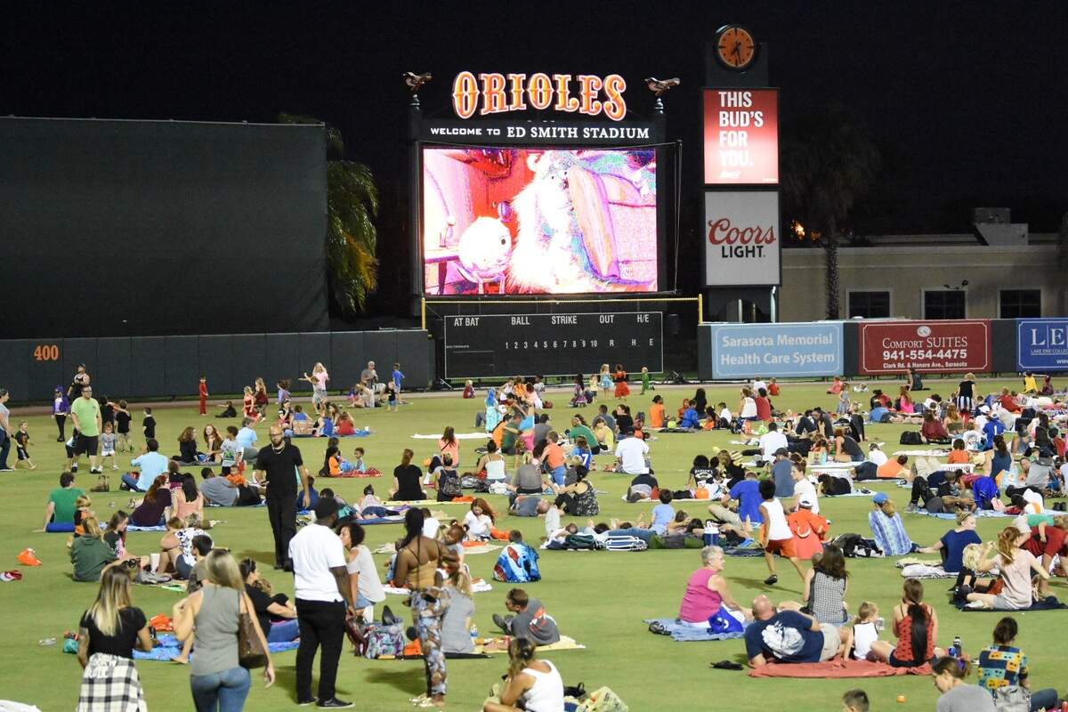 Families spread out on the field at Ed Smith Stadium to watch a Halloween movie at the 2017 Howl-O-Ween Movie Night Spectacular.