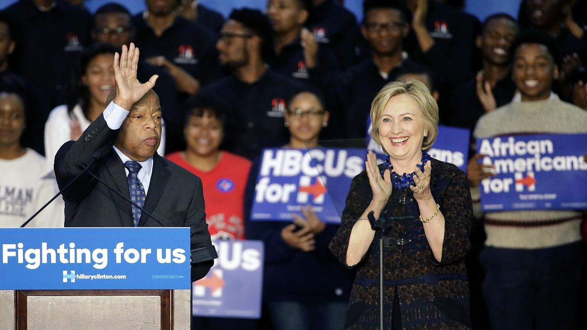 Democratic presidential candidate Hillary Rodham Clinton, right, and Rep. John Lewis, D-Ga., step onstage during a campaign event for Clinton at Clark Atlanta University on Friday in Atlanta. ASSOCIATED PRESS