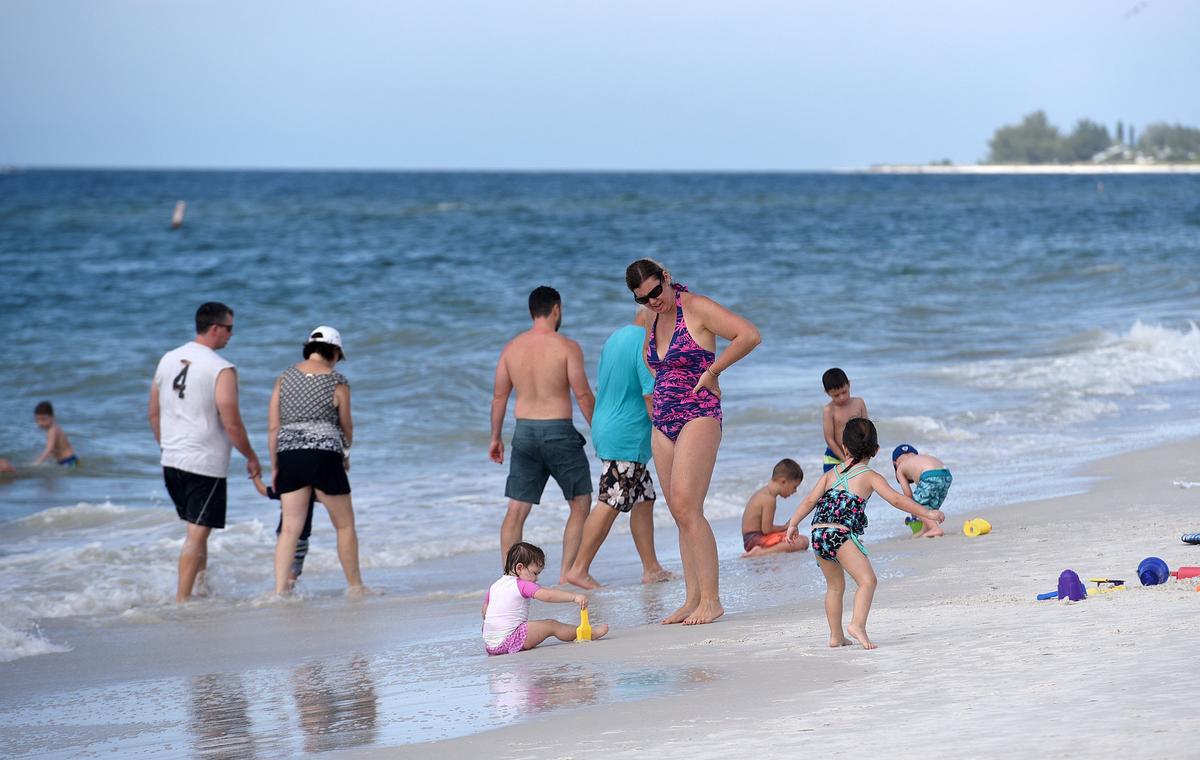 Visitors enjoy the sun and sand at the Manatee County Public Beach on Tuesday.
