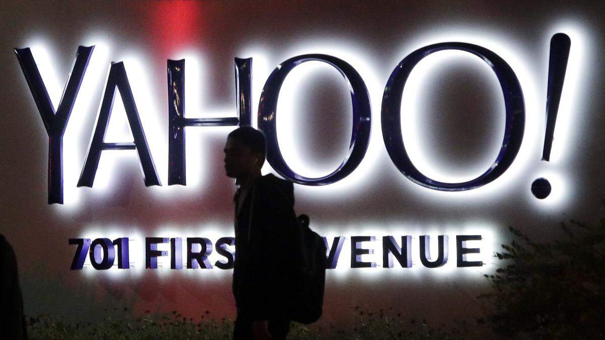 FILE - In this Nov. 5, 2014, file photo, a person walks in front of a Yahoo sign at the company's headquarters in Sunnyvale, Calif. Yahoo reports financial results on Tuesday, April 19, 2016. (AP Photo/Marcio Jose Sanchez, File)