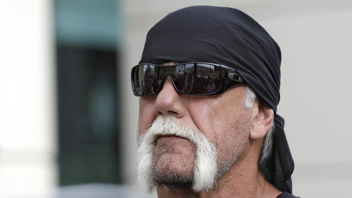 In this Oct. 15, 2012, file photo, reality TV star and former pro wrestler Hulk Hogan, whose real name is Terry Bollea, looks on as his attorney speaks in Tampa, Fla. World Wrestling Entertainment Inc. has reinstated Hogan to its Hall of Fame, three years after he was found to have used racial slurs in a conversation caught on a sex tape.