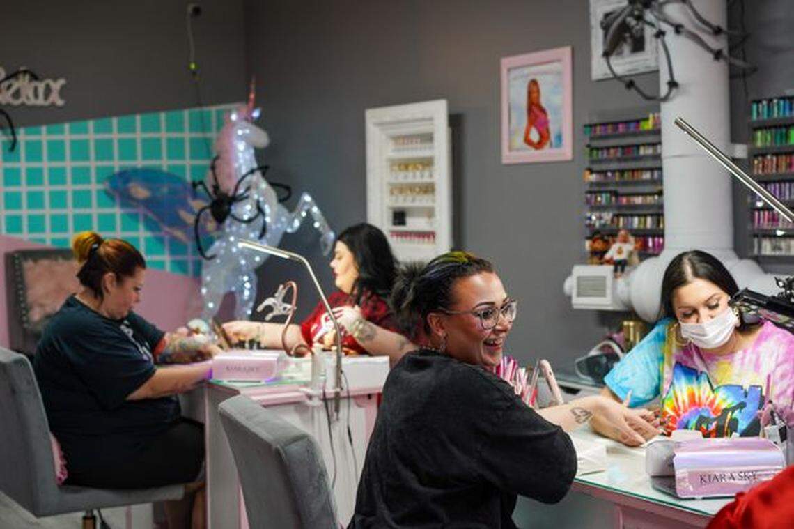 Devin Strebler and Melissa Gratton work alongside each other at Nail Addicts in Largo on Nov. 1, 2022.