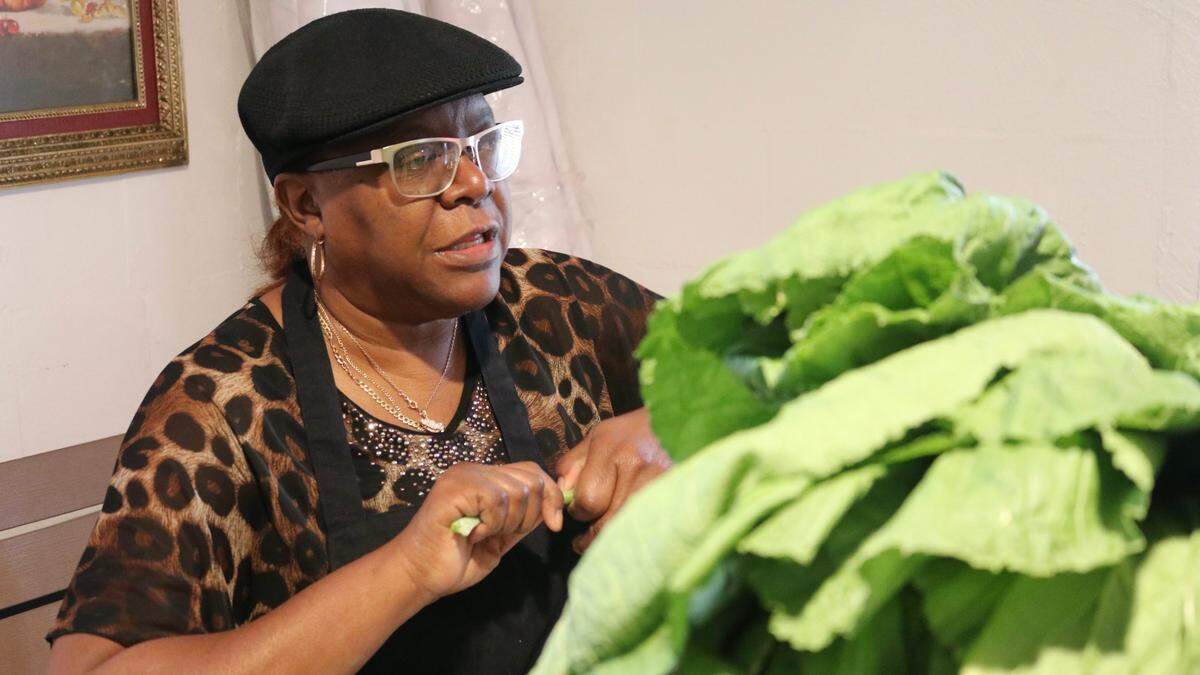 Sharon Scott Isom picks through a mountain of collards and mustard greens Dec. 15, 2022, that would be served on Soul Food Sunday at Rock Inn Restaurant, 2112 Second Ave. E., Palmetto.
