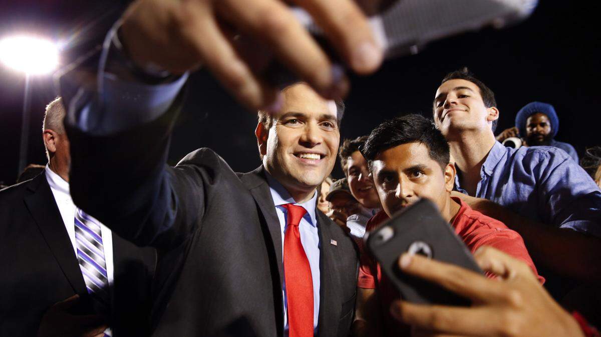 Republican presidential candidate, Sen. Marco Rubio, R-Fla., poses for photographs during a campaign rally in Hialeah, Wednesday. AP Photo/PAUL SANCYA