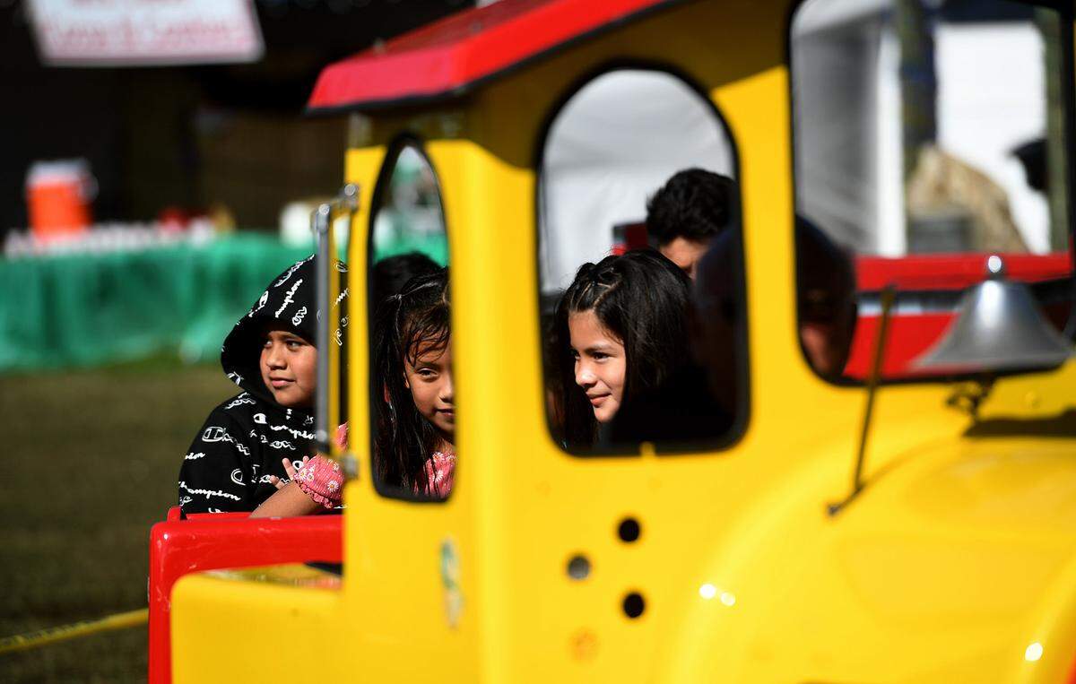 12/08/21—Kids ride a small train at a party after a ride on the North Pole Express from the Florida Railway Museum for a trip to meet Santa at the 36th annual event for terminally ill children.