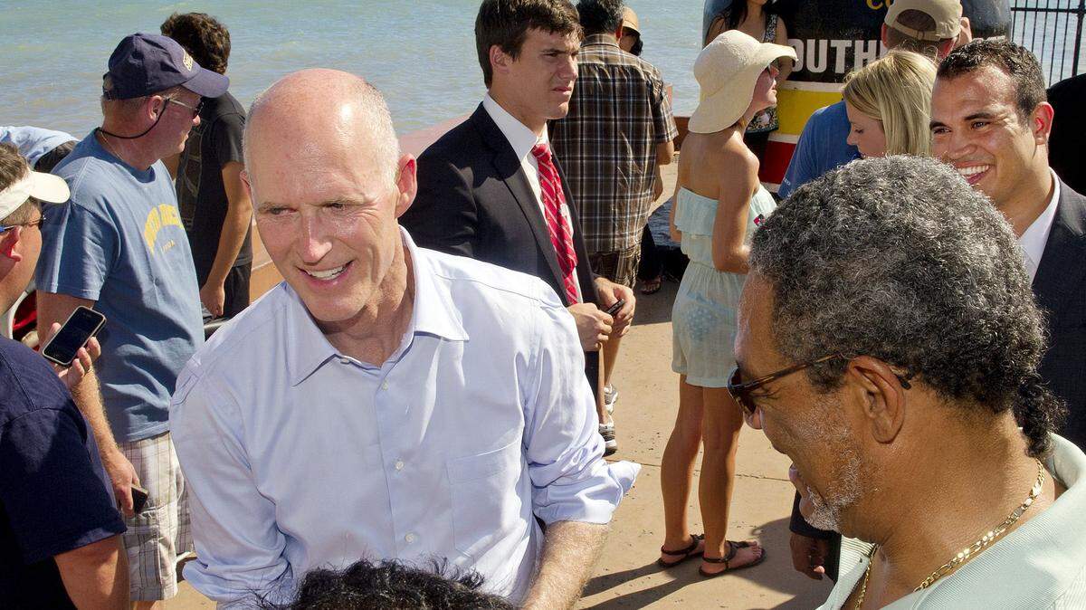 Florida Governor Rick Scott meets with visitors to the Southernmost Point marker in Key West, Fla., Saturday, June 4, 2011. AP File Photo/The Key West Citizen, Rob O'Neal