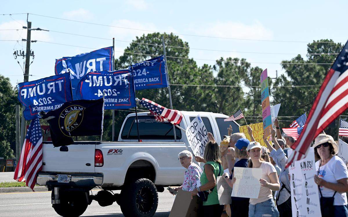 Hundreds attend the No Kings protest organized by Indivisible Manatee near the University Town Center along University Parkway on June 14, 2025. A passing truck decked in Trump flags was met with good-natured cheers by the group as they waved anti-Trump signs and flags.
