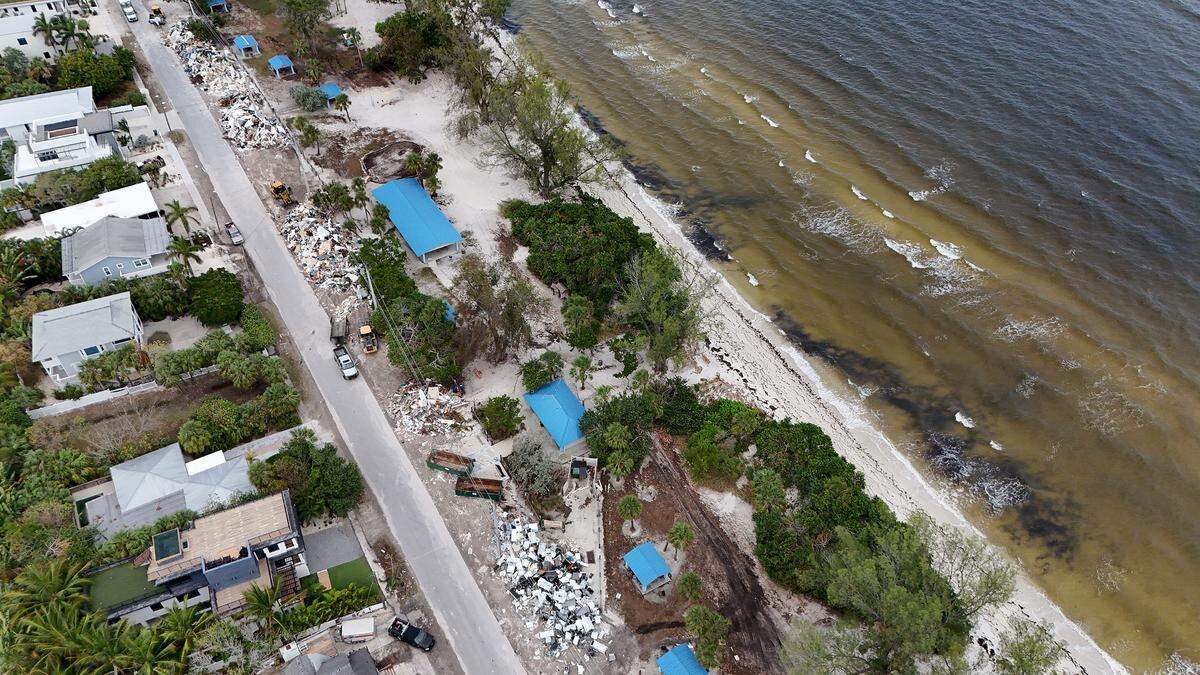 A massive amount of storm debris is stacked on N. Bay Drive on Anna Maria Island where dump trucks come haul away loads as Hurricane Milton approaches Manatee County on Oct. 8, 2024.