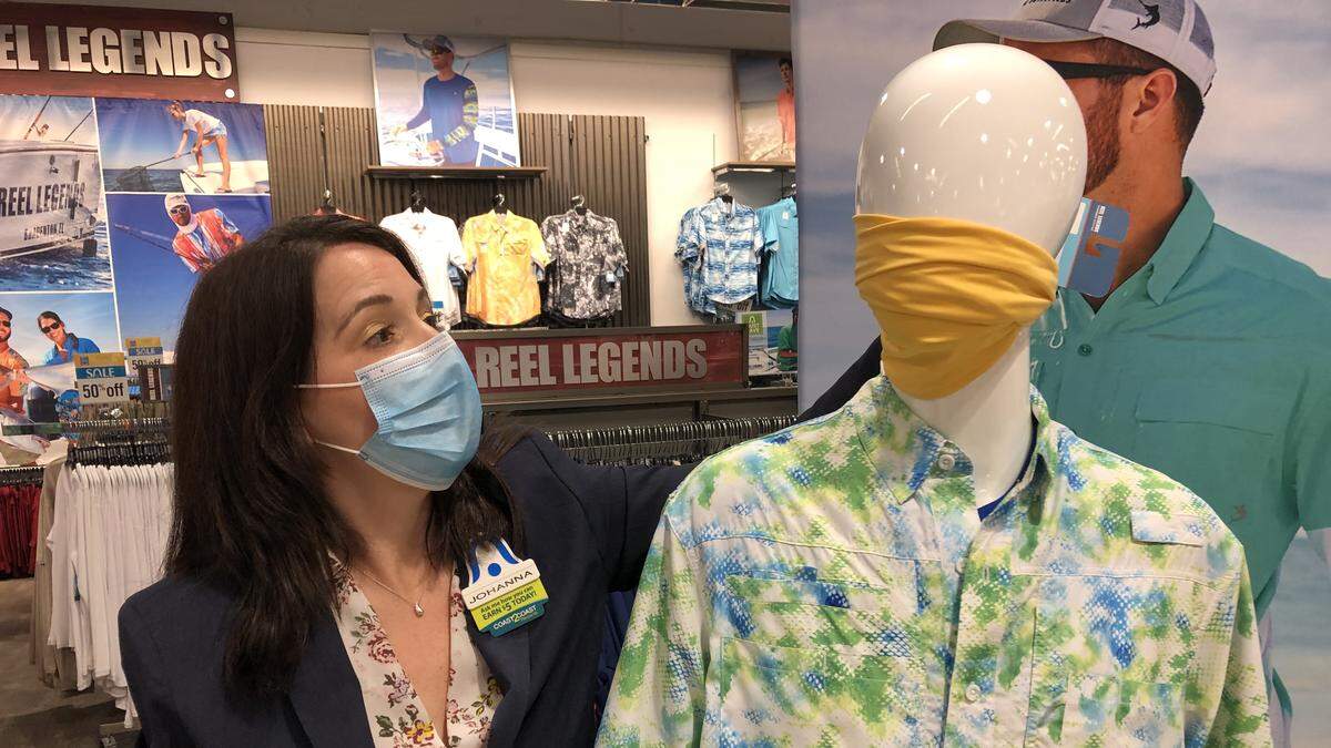Joanna Reilly, manager of the Bealls store at 6837 Manatee Ave. E., displays one of the face wraps that customers were ordering online, when retail stores were closed by executive order of Ron DeSantis, governor of Florida.