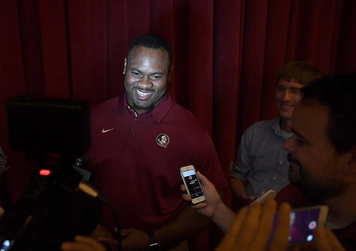 Demarcus Christmas smiles at an event with Coach Willie Taggart at the Mertz Theatre in Sarasota on a bus tour Monday night.