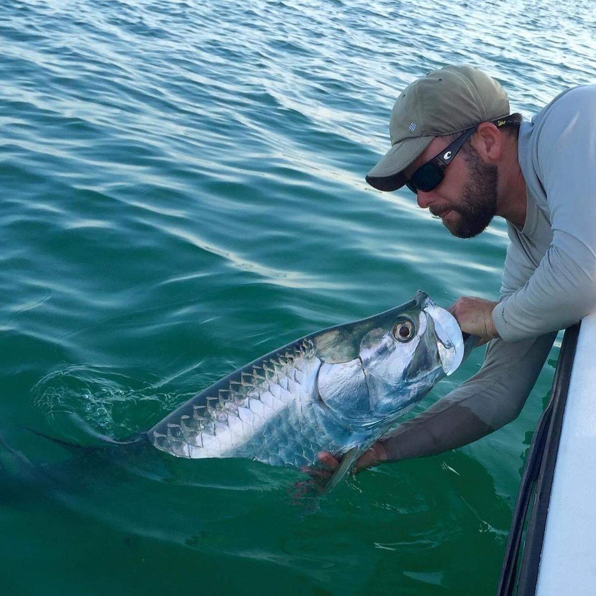Captain Jason Wightman holds a tarpon. He runs a charter fishing business called Grande Tarpon Charters out of Palmetto.