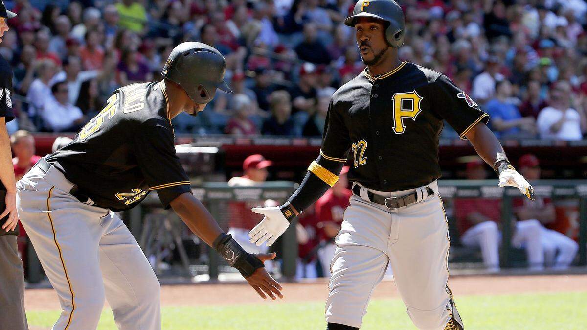 Pittsburgh Pirates' Andrew McCutchen (22) celebrates with Gregory Polanco (25) after both scored on a two-run double by Neil Walker during the fifth inning of a baseball game against the Arizona Diamondbacks Sunday, April 26, 2015, in Phoenix. (AP Photo/Ross D. Franklin)