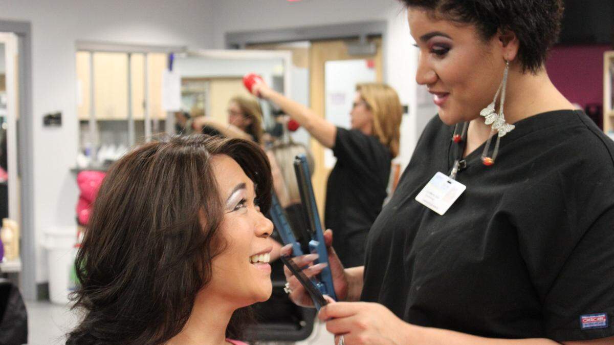 Cheryl Bourque of Manatee County School District has her hair styled Saturday by cosmetology student Lynn Marie Ortiz at the Manatee Technical College "Day of Beauty." 
 PHOTO PROVIDED.
