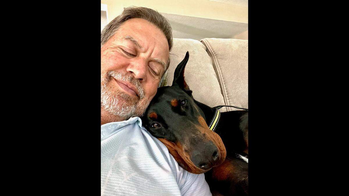 Paul Evans with his dog, Stella, a 1 and a half-year-old Doberman Pinscher. Stella died during her last stint at Euro Pros K-9 Center, according to her owners.