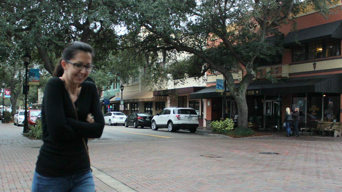 Courtney Robertson bundles up against the chill on Bradenton's Old Main Street on Sunday afternoon. A cool front arrived late Saturday and early Sunday bringing 60 degree temperatures and all-day showers.JAMES A. JONES JR./Bradenton Herald