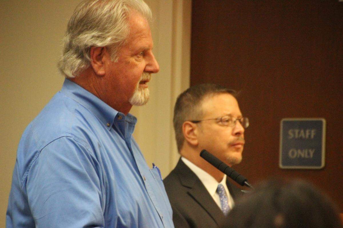 John Barnott, Manatee County building services director, left, and Bill Clague, a Manatee County government attorney, talk to county commissioners about a proposed City of Palmetto annexation on Snead Island.