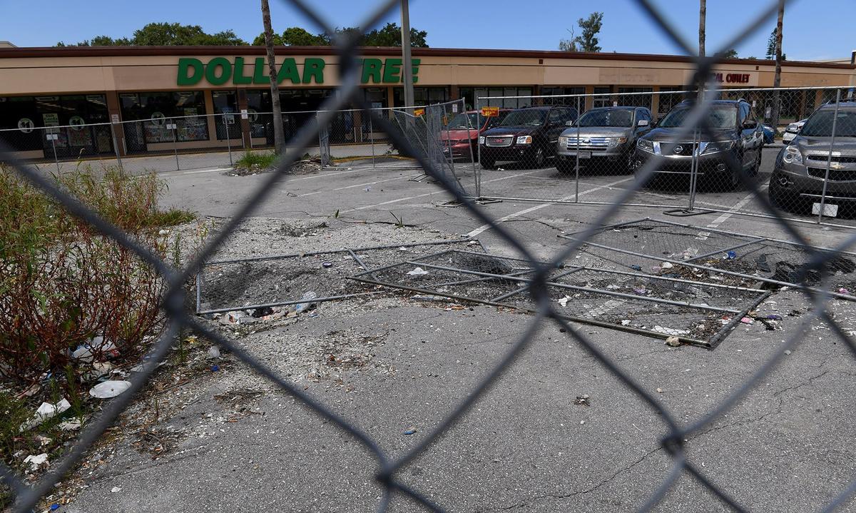 The sinkholes in Cortez Plaza continue to grow as businesses carry on as usual around fenced off areas.