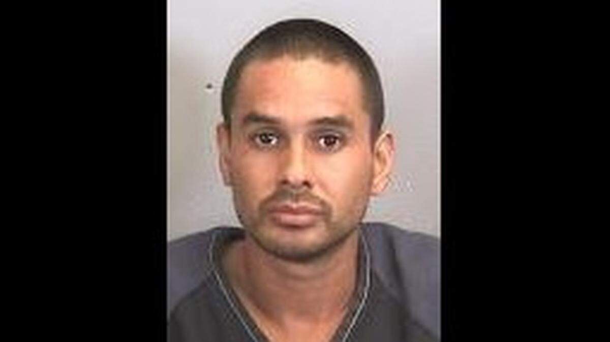 Dani Santos-Villatoro, 32, was arrested Tuesday on one count of aggravated assault after deputies say he pointed a silver handgun at a customer's head during a dispute. Santos-Villatoro is the owner of Danny's Auto Body Shop on 15th Street East, where the incident occurred.