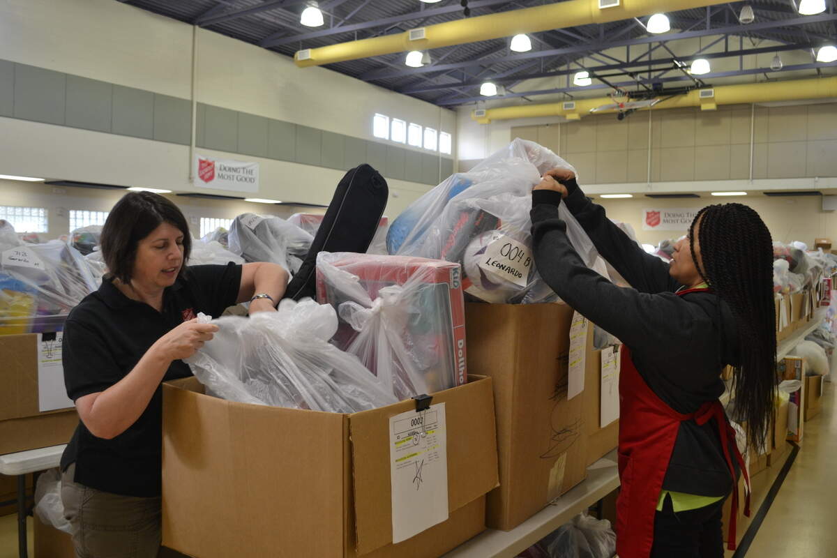 Kelly French, left, and Georgette Franklin, with Salvation Army of Manatee County, inspect bags of presents before parents arrive to pick them up.