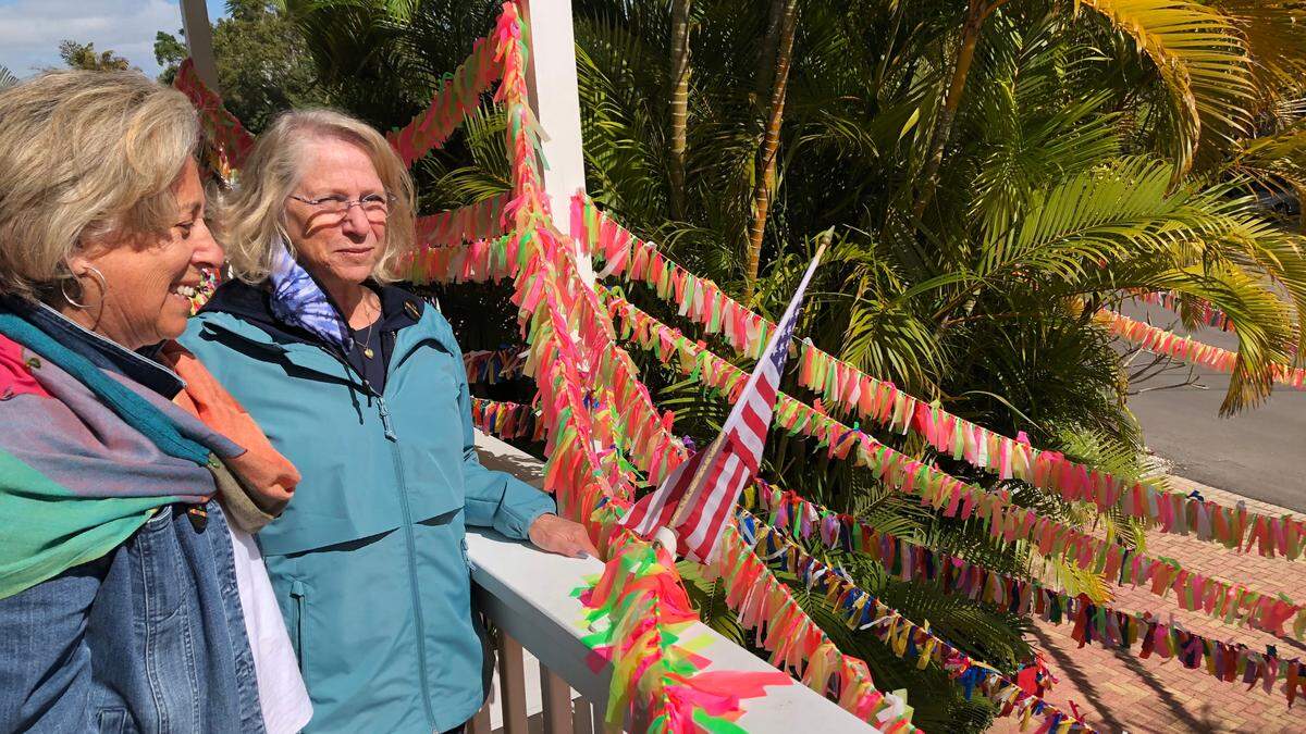 2/2/2021--Anna Maria residents Lucy Kanson, left, and Cathy Tobias, with the help of other volunteers, plan to unfurl a memorial chain on the beach Feb. 16, commemorating the more than 26,000 Floridians who have died of COVID-19. The chain contains one ribbon for each person who has died during the pandemic and is estimated to be more than two football fields long.