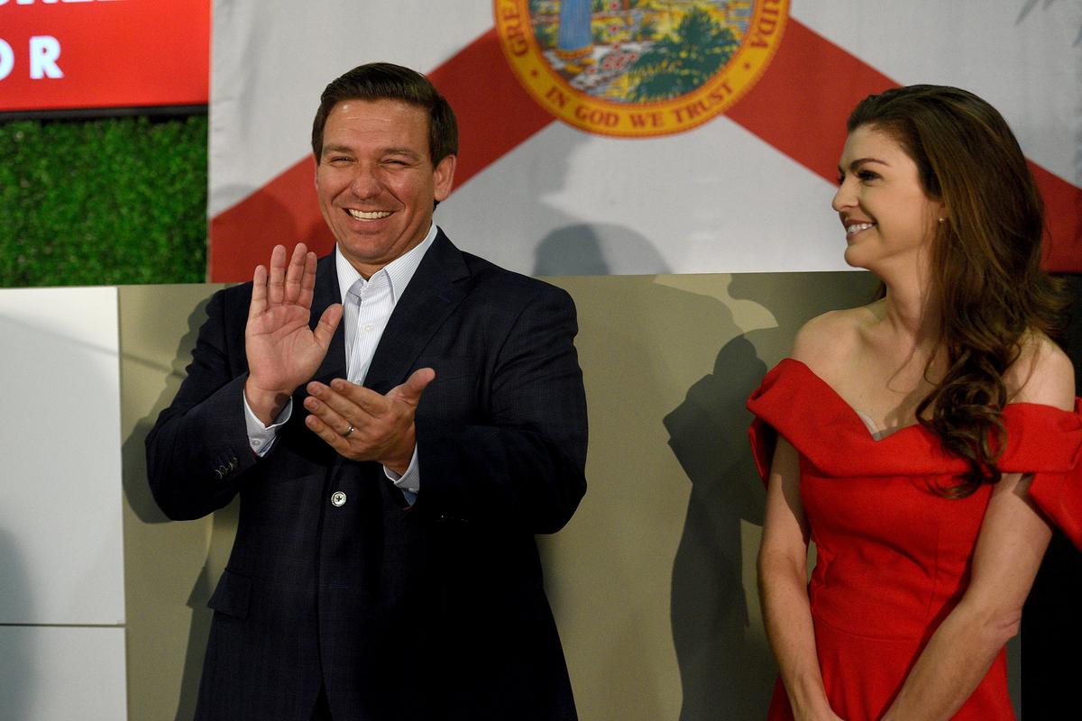 Republican candidate for governor, Ron DeSantis with wife, Casey, talks to a crowd during a campaign rally stop at Dolphin Aviation Wednesday morning.