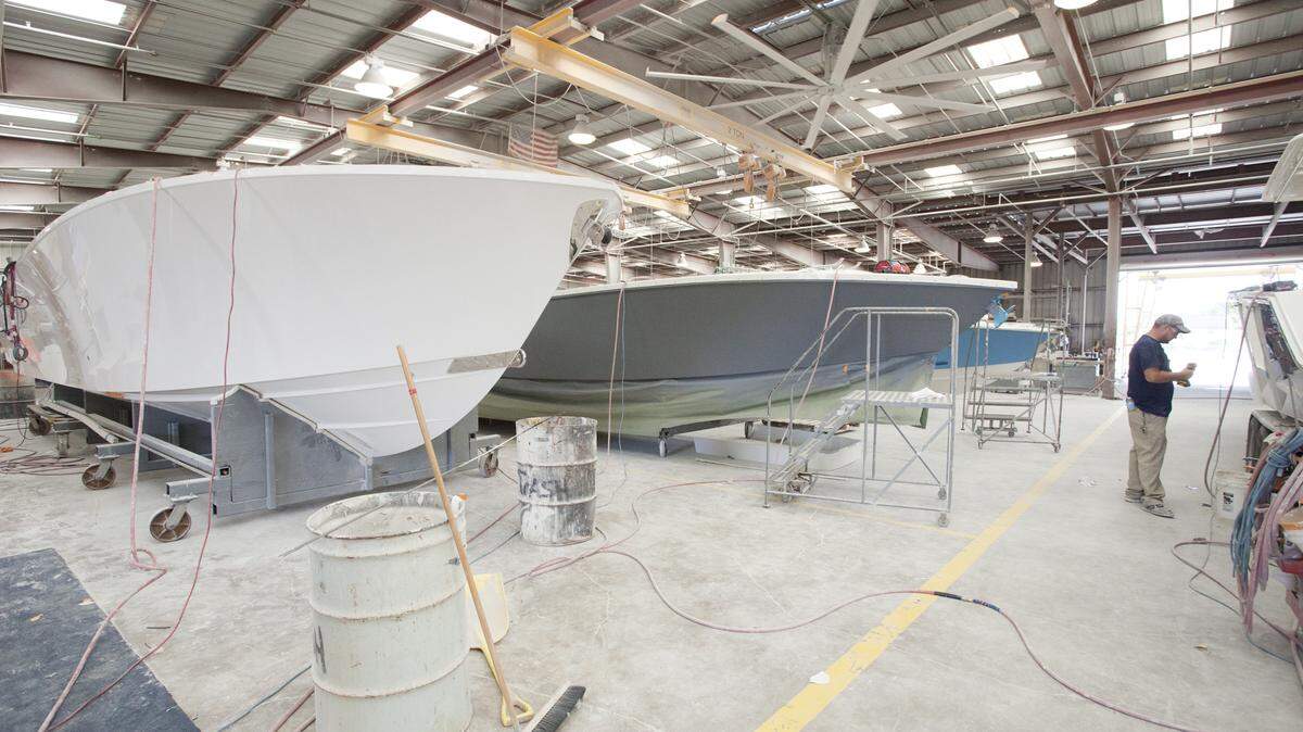FILE: Lined up for finsh work in 2014 are the hulls of a batch of Jupiter Marine's boats at Jupiter's Palmetto manufacturing facility. MATT M. JOHNSON/BRADENTON HERALD