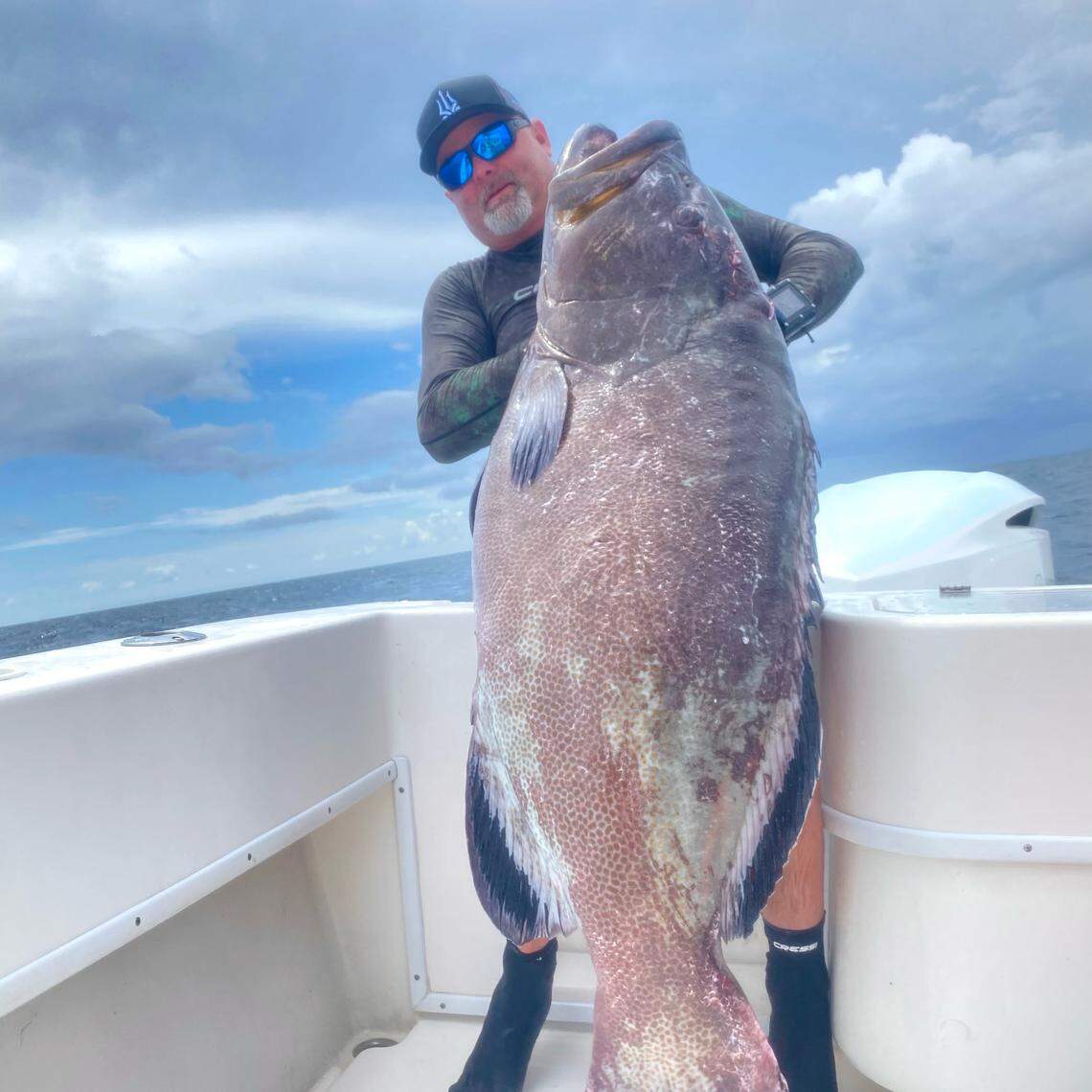 Brett Booth poses with the first-place black grouper speared during the 58th Annual St. Pete Open spearfishing tournament.