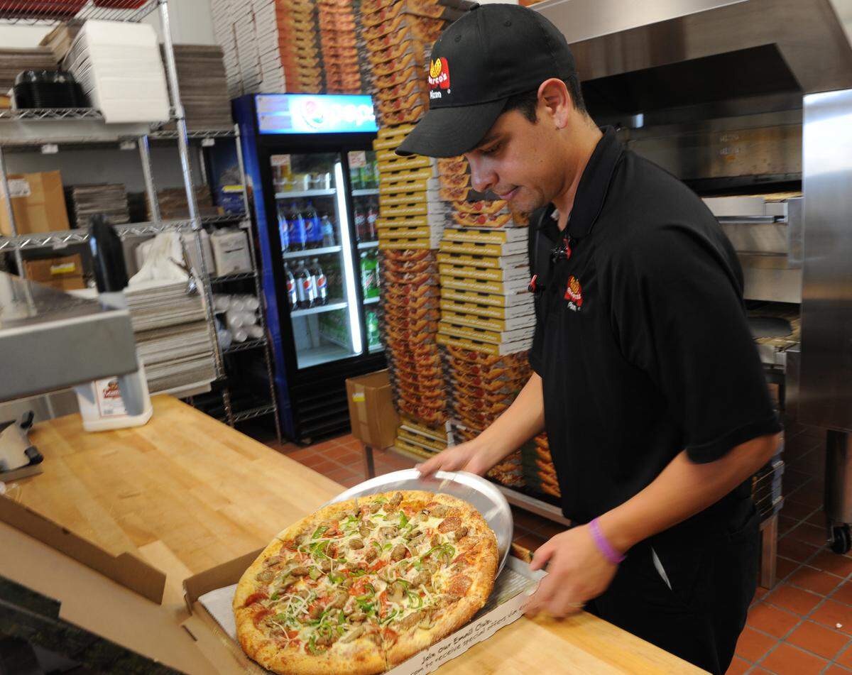 A fresh pie is boxed up at Marco’s Pizza.