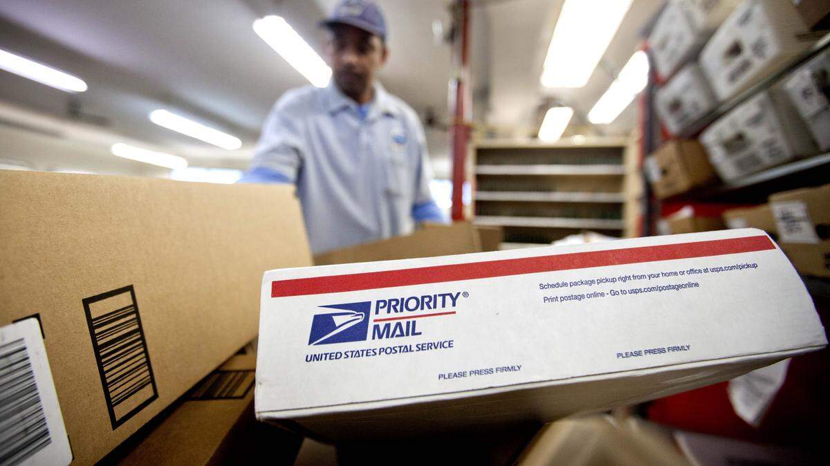 FILE - In this Feb. 7, 2013 file photo, packages wait to be sorted in a Post Office in Atlanta. The Postal Service on Friday reported a $5.1 billion loss for the just-completed 2015 fiscal cycle ó but that's a slight improvement over last year. (AP Photo/David Goldman, File)