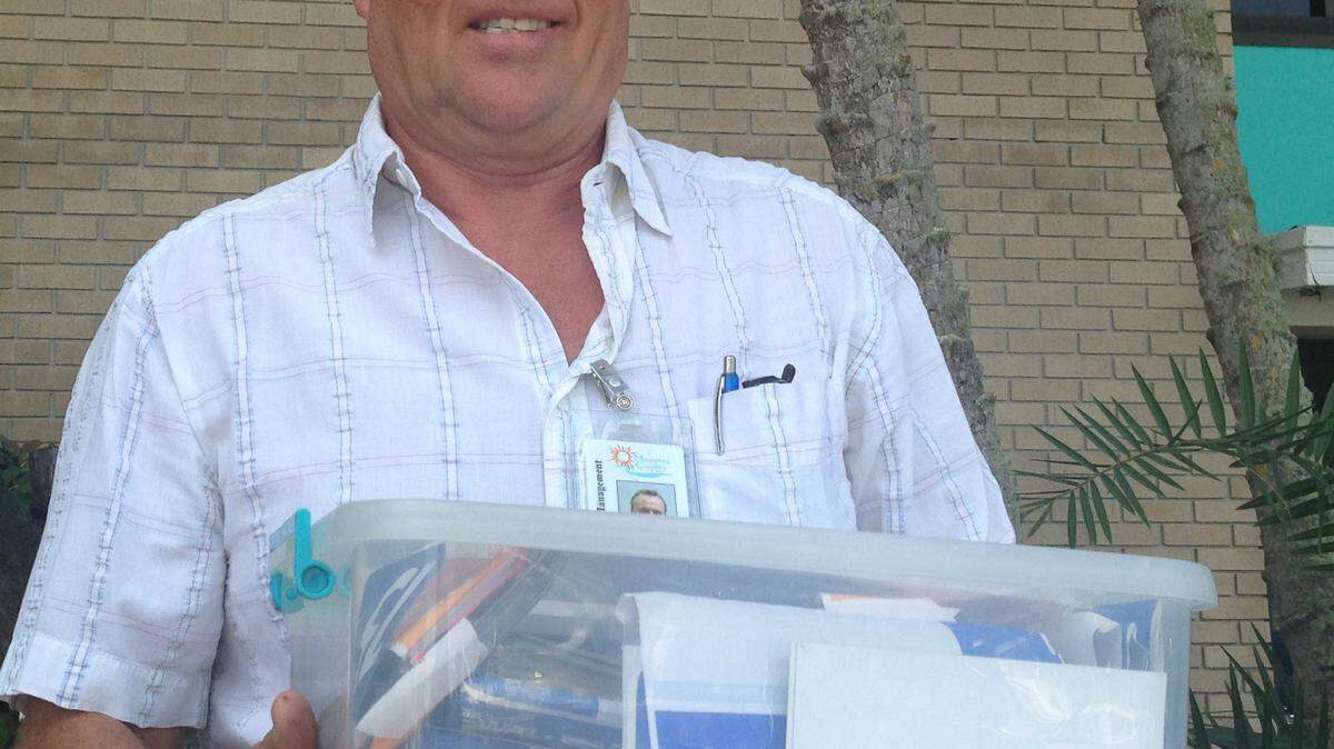 Dave Dillard hopes to return this tub of family photos to their owner. He found them while jogging at Lakewood Ranch.JAMES A. JONES JR./Bradenton Herald