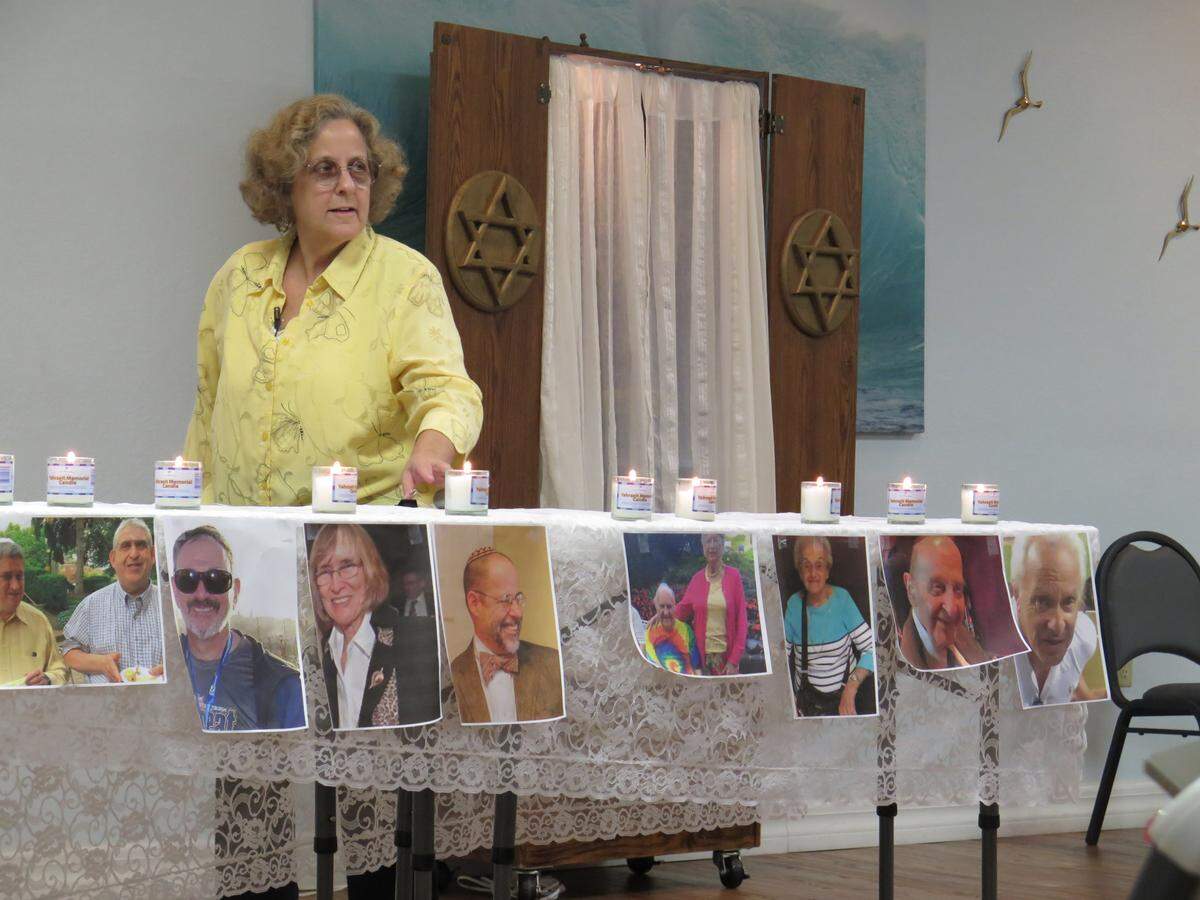 Rabbinic associate Rena Morano leads a Jewish prayer service at Congregation Ner Tamid Friday evening. The gathering was part of a  national “Show Up For Shabbat” effort following a deadly shooting in Pittsburgh. The 11 victims were honored with Yahrzeit memorial candles meant to symbolize an everlasting soul.