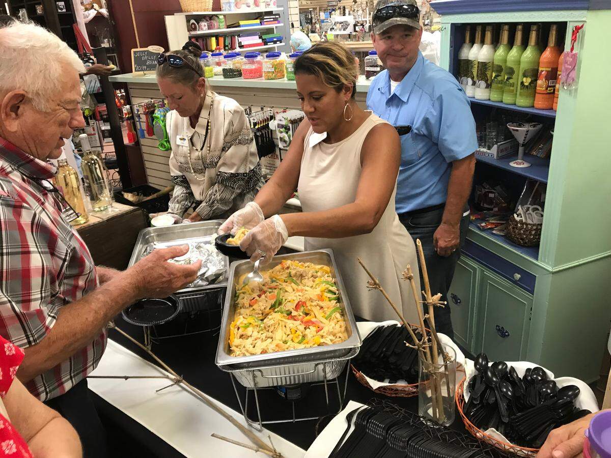 Customers line up for a sample of chicken curry made with bamboo Thursday at Mixon Fruit Farms, 2525 27th St. E., Bradenton. The bamboo is being grown for food and is an emerging crop in Florida.