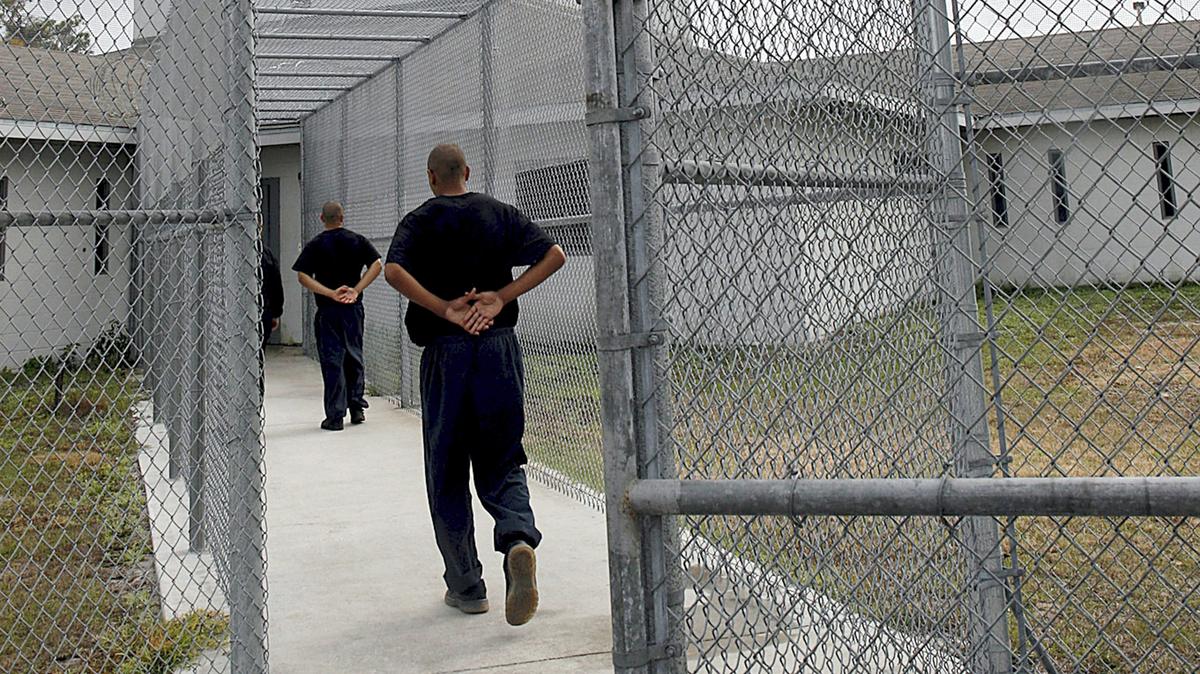Two young men return to the high-security building after outside recreation time at Palmetto Youth Academy in this photo from 2009.