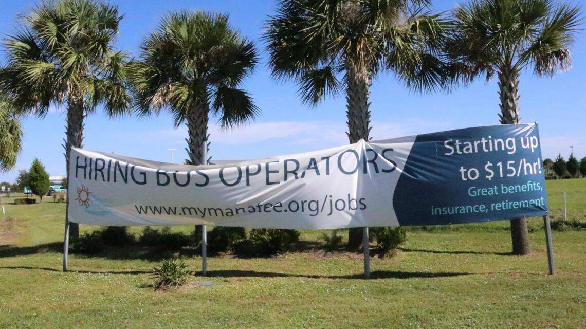 20/30/2021--Manatee County government has a banner&nbsp; announcing that it is hiring drivers for up to $15 an hour, plus benefits, insurance and retirement. The banner and county facility is located opposite the new Amazon facility on Tallevast Road.