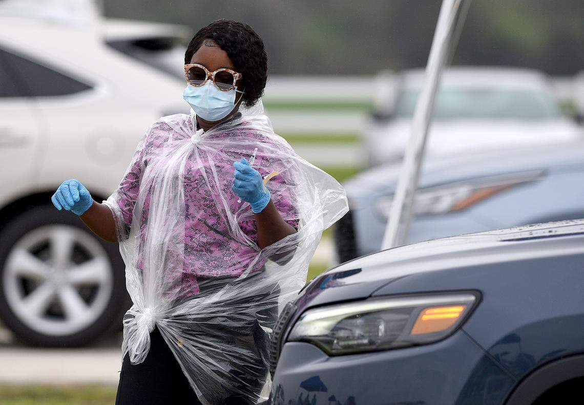 02/17/21--A nurse in makeshift rain gear attends to vaccinations at the Premier Sports Campus where Gov. Ron DeSantis made a stop to host a press conference at the Lakewood Ranch pop-up COVID-19 vaccination site aimed at inoculating more senior citizens. DeSantis faced criticism over the site, which stands to vaccinate some of Manatee’s wealthiest residents.
