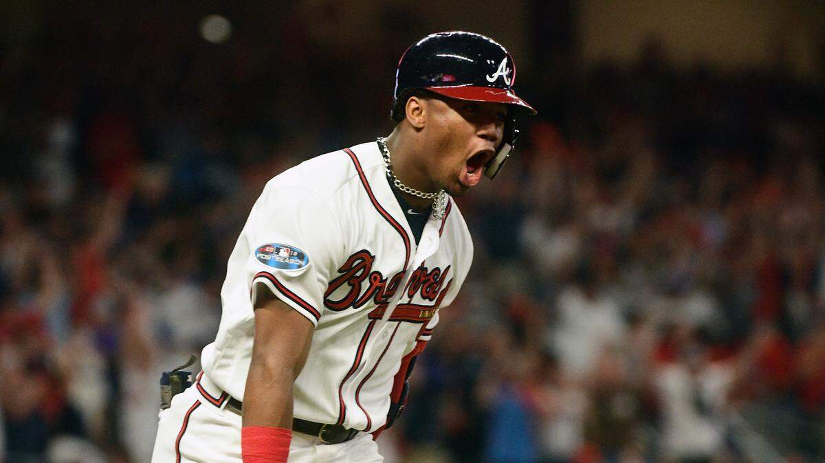 Atlanta Braves’ Ronald Acuna Jr. (13) runs to first after hitting a grand-slam homer against Los Angeles Dodgers starting pitcher Walker Buehler during the second inning in Game 3 of MLB baseball’s National League Division Series, Sunday, Oct. 7, 2018, in Atlanta.