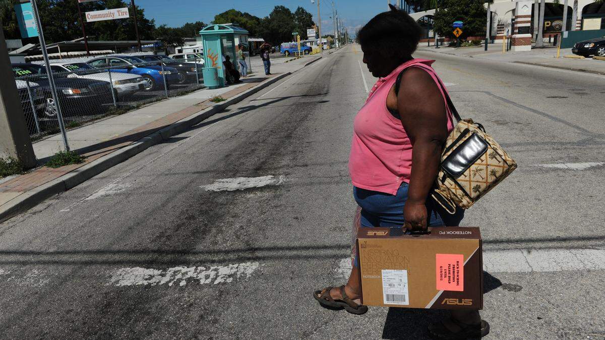 Gwen, 45, walks to the bus stop at Ninth Street West and 17th Avenue West after visiting the One Stop Center in Bradenton. Gwen is one of many homeless women living on the streets of Manatee County. 
 GRANT JEFFERIES/Bradenton Herald
