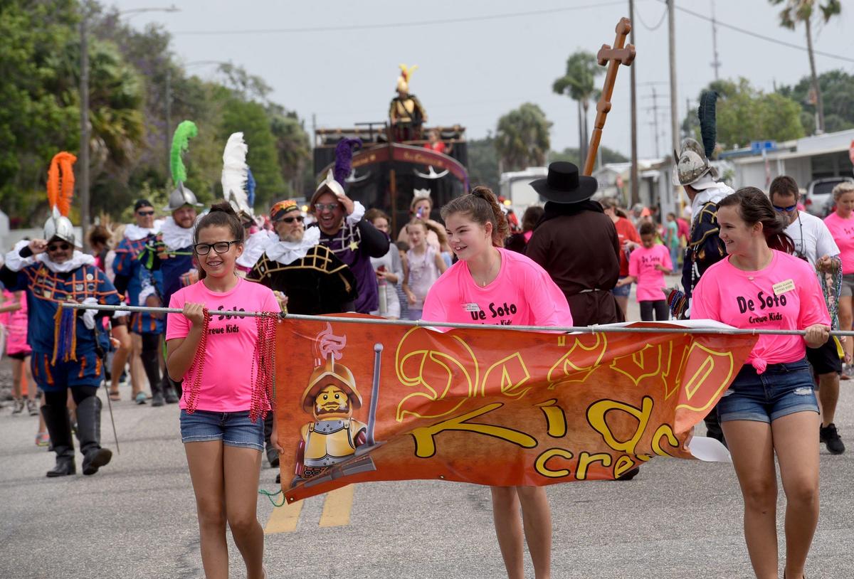 Children fight the wind while walking in the annual DeSoto Children’s Parade in Palmetto.