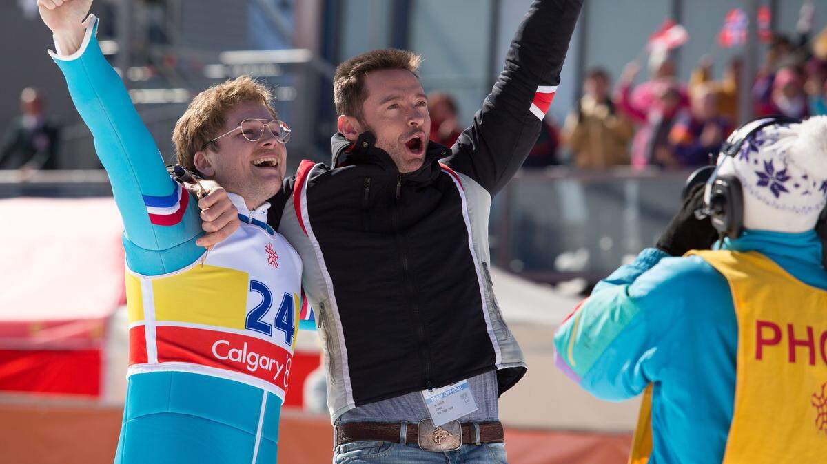 Taron Egerton, left, and Hugh Jackman appear in a scene from "Eddie the Eagle." Larry Horricks/20th Century Fox via AP