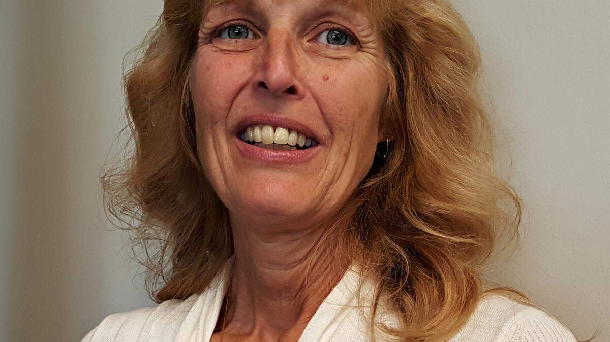 Suzanne Theiss, the Southeast High School senior school secretary, works with students who forget their IDs. Theiss is one of four support employee finalists for the district's Excellence in Education award.