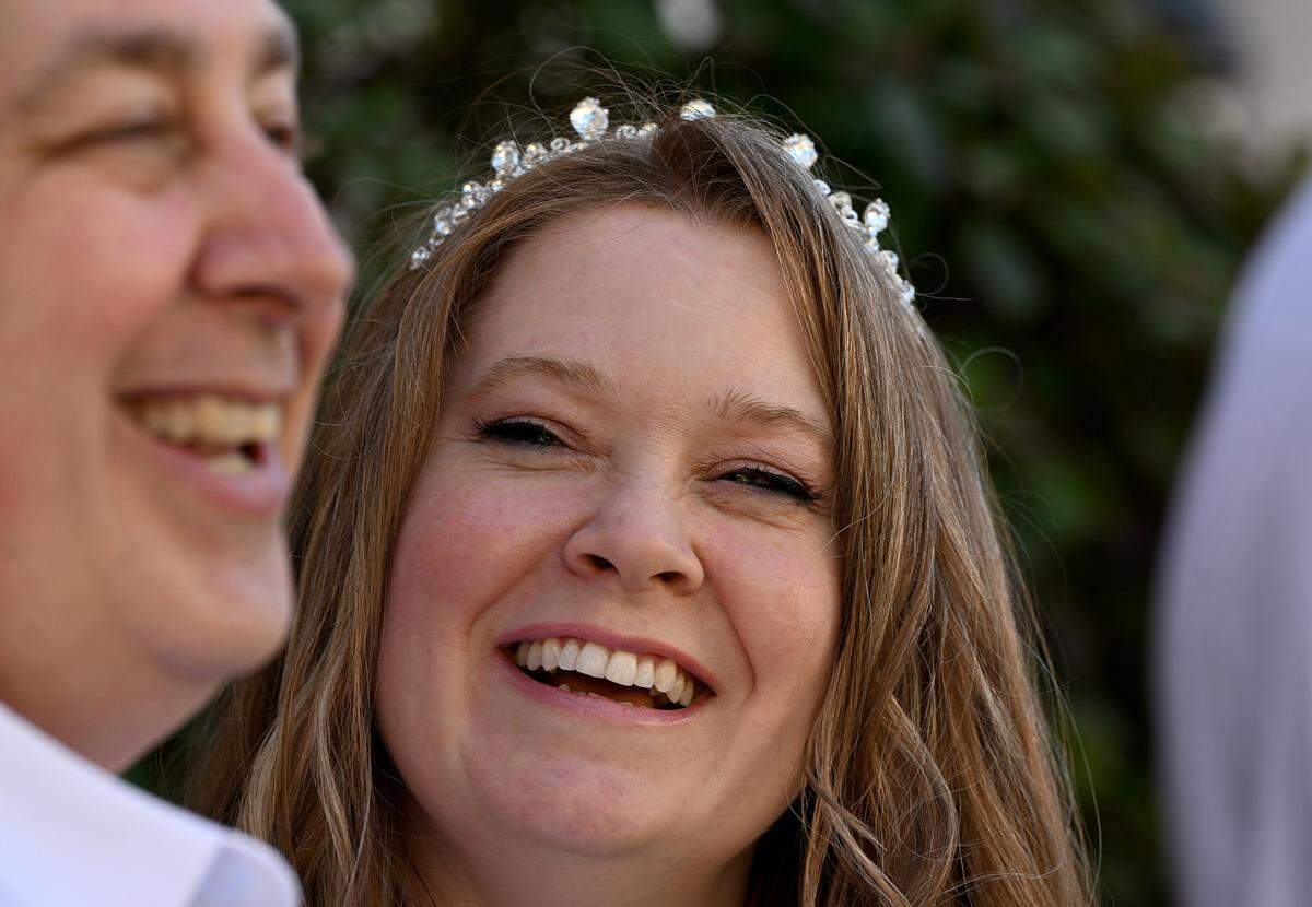 Maryse Mead and Randall Walker smile before getting married in a group ceremony on Valentine’s Day beside the Historic Manatee County Courthouse on Feb. 14, 2024.