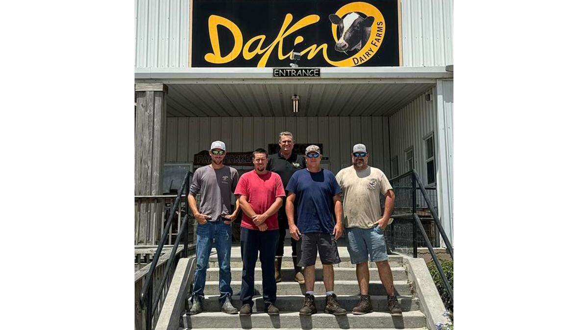 Brothers Jason, Garrett, Grant, and Ethan Dakin are shown with Jerry Dakin (back) after the announcement that Dakin Dairy in Myakka City is staying in the family.