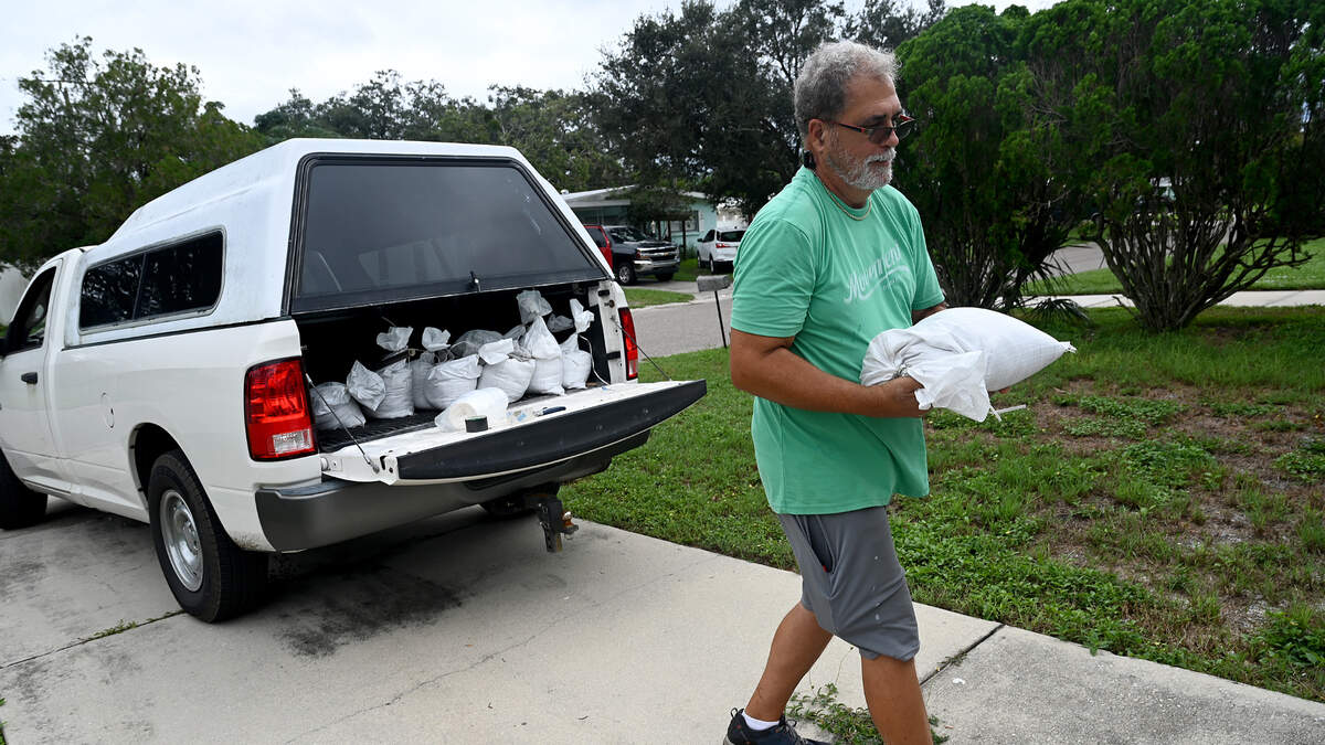 George Bourne readies his home in Bradenton for the second hurricane in the span of a month as Hurricane Milton approaches Manatee County on Monday, Oct. 7, 2024.