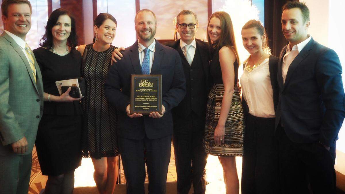 The Mirabella at Village Green subdivision in Bradenton gave first-time Manatee housing developer Marshall Gobuty his first Parade of Homes award Thursday. Posing with the award for best overall multi-family subdivision in the 151-200-unit category were Christian Carson, Dina Gobuty, Sara Jannopoulo, Joe Jannopoulo, Mashall Gobuty, Meg Carson, Monique Viehman and Scott Viehman. PHOTO PROVIDED