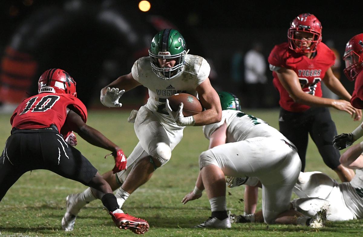 Venice’s Brandon Gregory pushes through Palmetto’s defense at the Palmetto vs. Venice game at Palmetto Friday night.